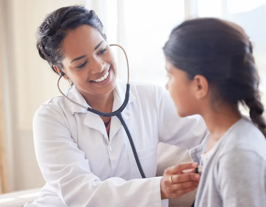 Primary Care Pediatric Nurse Practitioner Taking Heart Rate of Child Patient