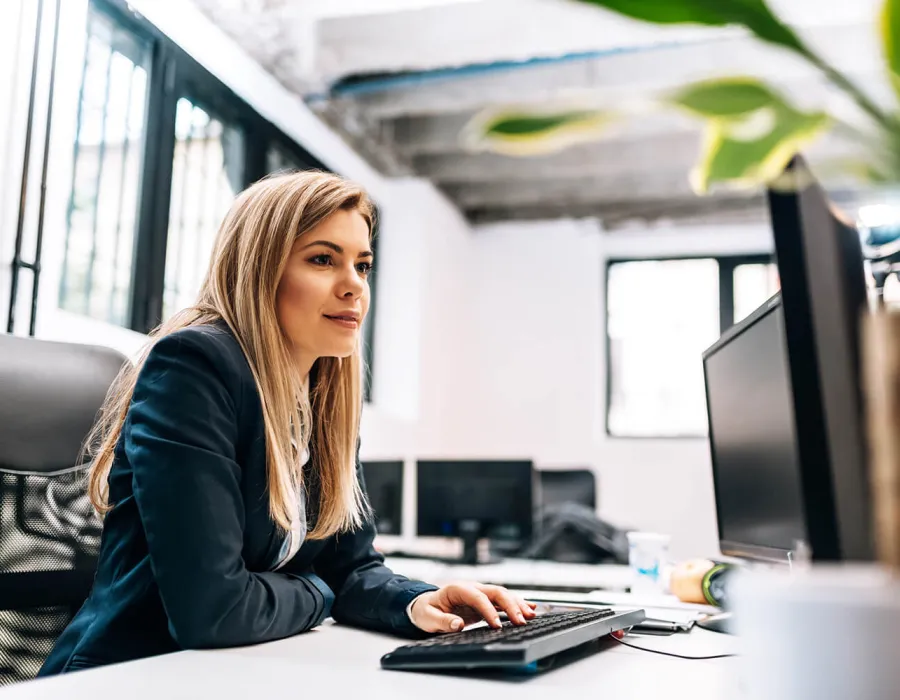 Health Information Technician Smiling at Desk