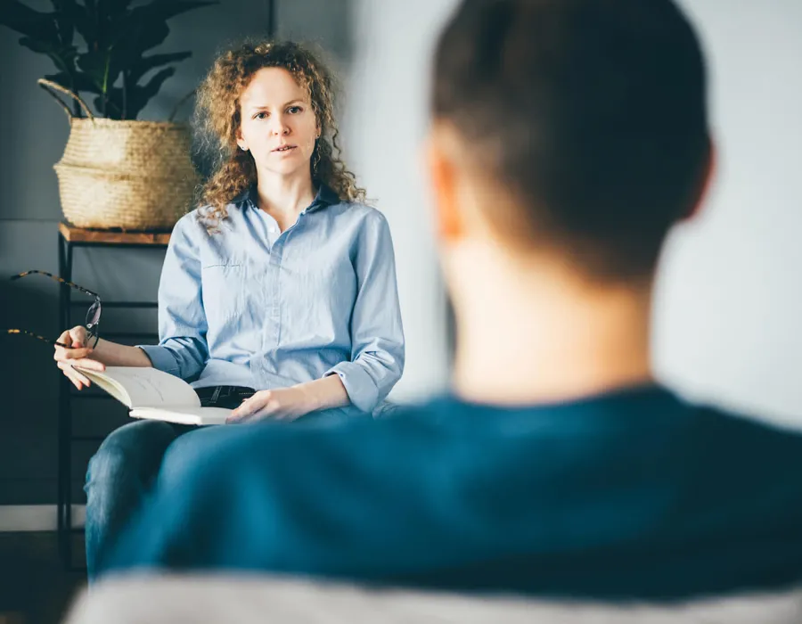 Social Worker Counseling with Client in Office