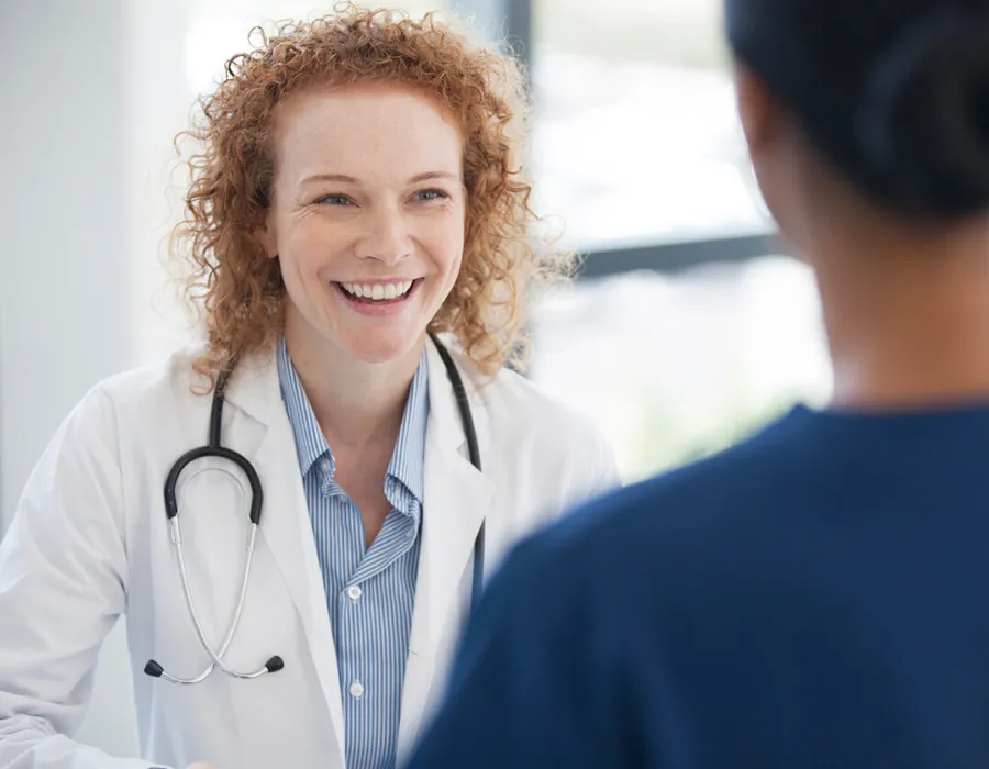 Public Health Nurse Smiling with Patient in Office