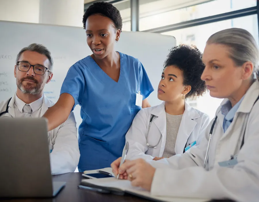 Healthcare team including RN and nurse practitioner discussing patient data