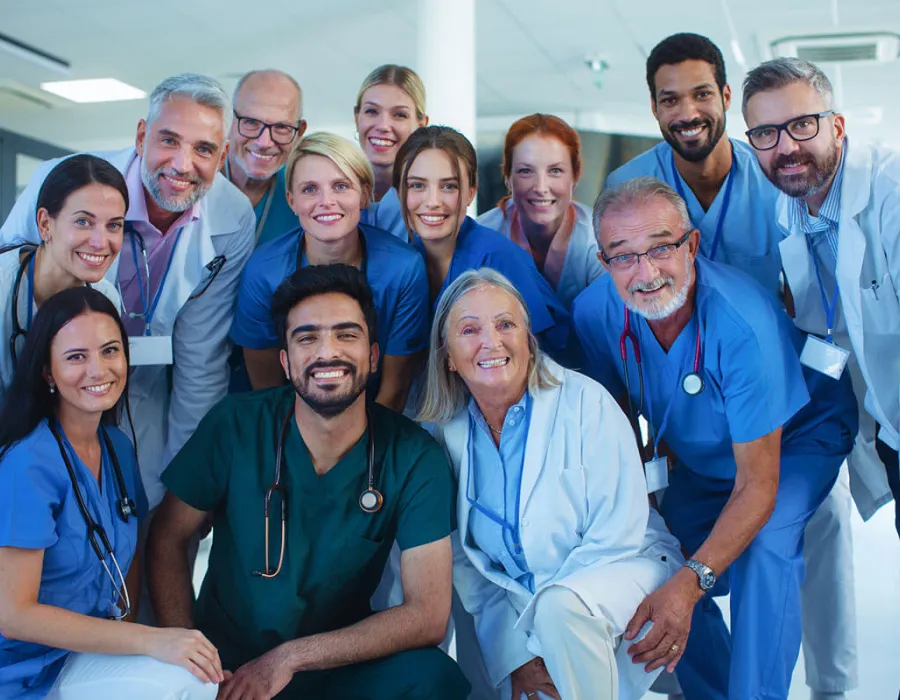 Team of healthcare professionals posing for group photo in hospital