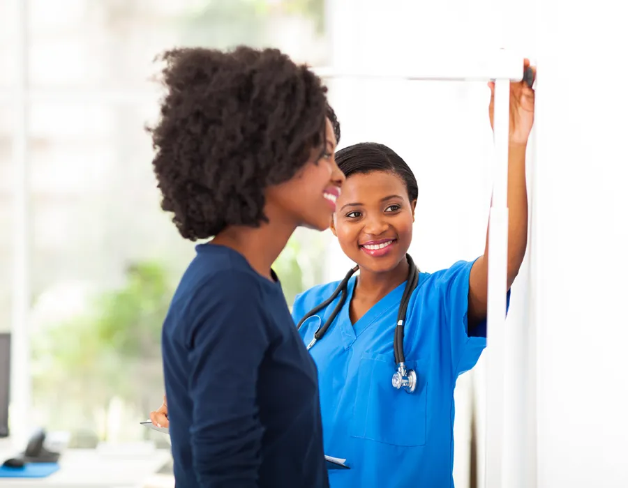 Medical Assistant Helping Patient in Clinic