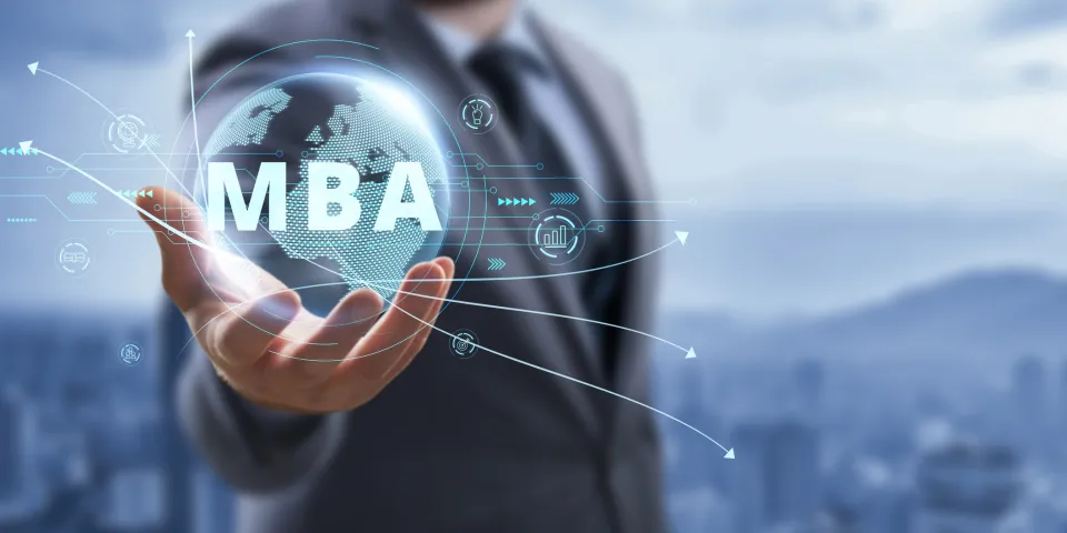 Man in a suit holding globe with MBA superimposed on top