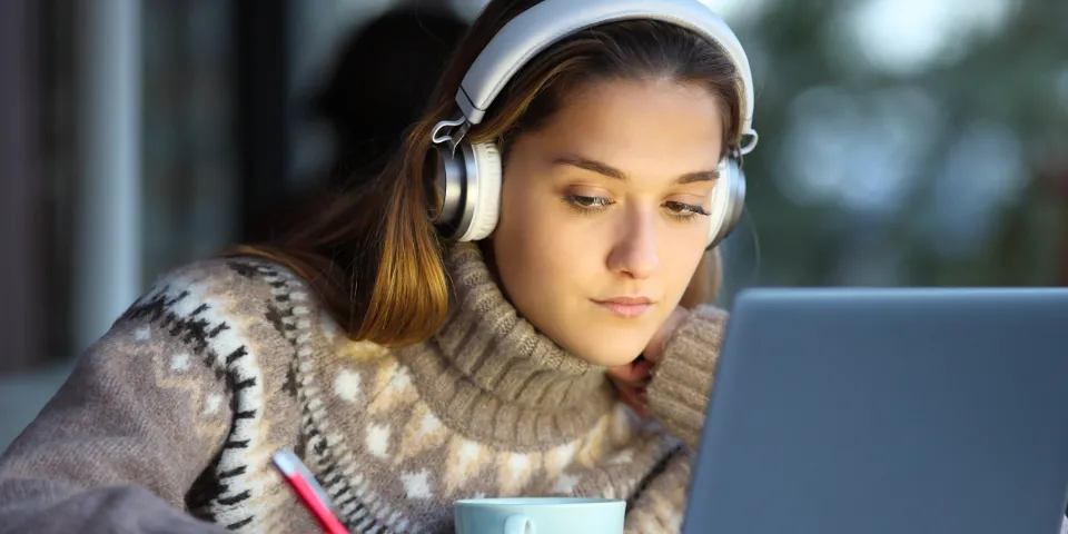 Student e-learning in a coffee shop in winter