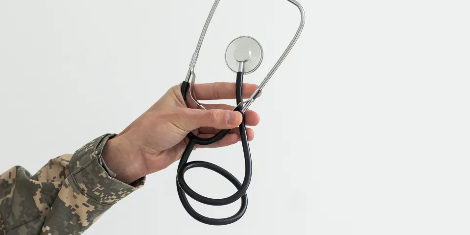 Young man army soldier holding stethoscope