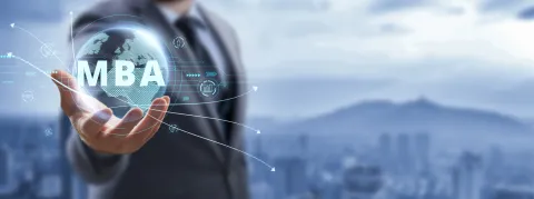 Man in a suit holding globe with MBA superimposed on top