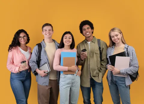 Five college students holding notebooks and folders