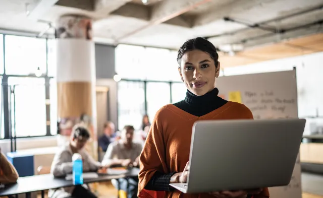 Portrait of a young woman using the laptop in the classroom